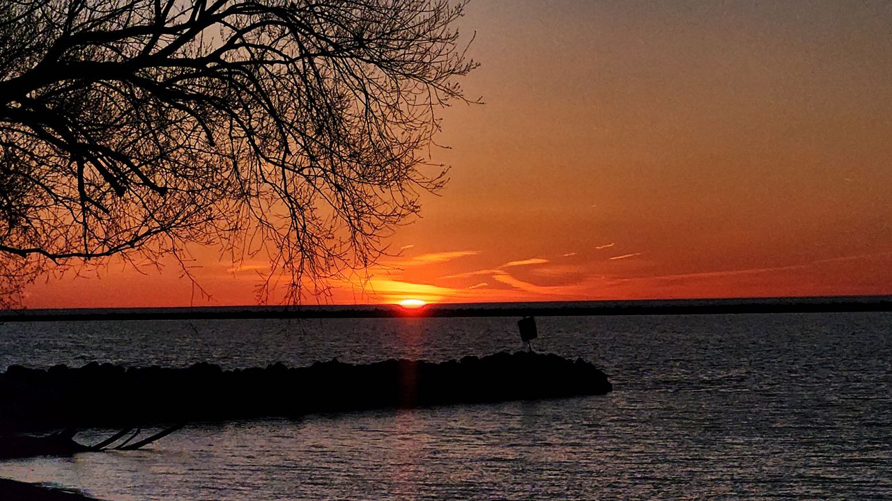 The sun sets over Lake Erie at Wendy Park in Cleveland, Ohio on April 13, 2024. (Spectrum News 1/Lydia Taylor)