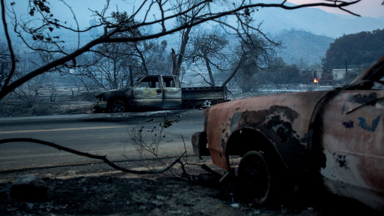 Burned vehicles are seen in the Lake Hughes fire in Angeles National Forest on Thursday, Aug. 13, 2020, north of Santa Clarita, Calif. (AP Photo/Ringo H.W. Chiu)