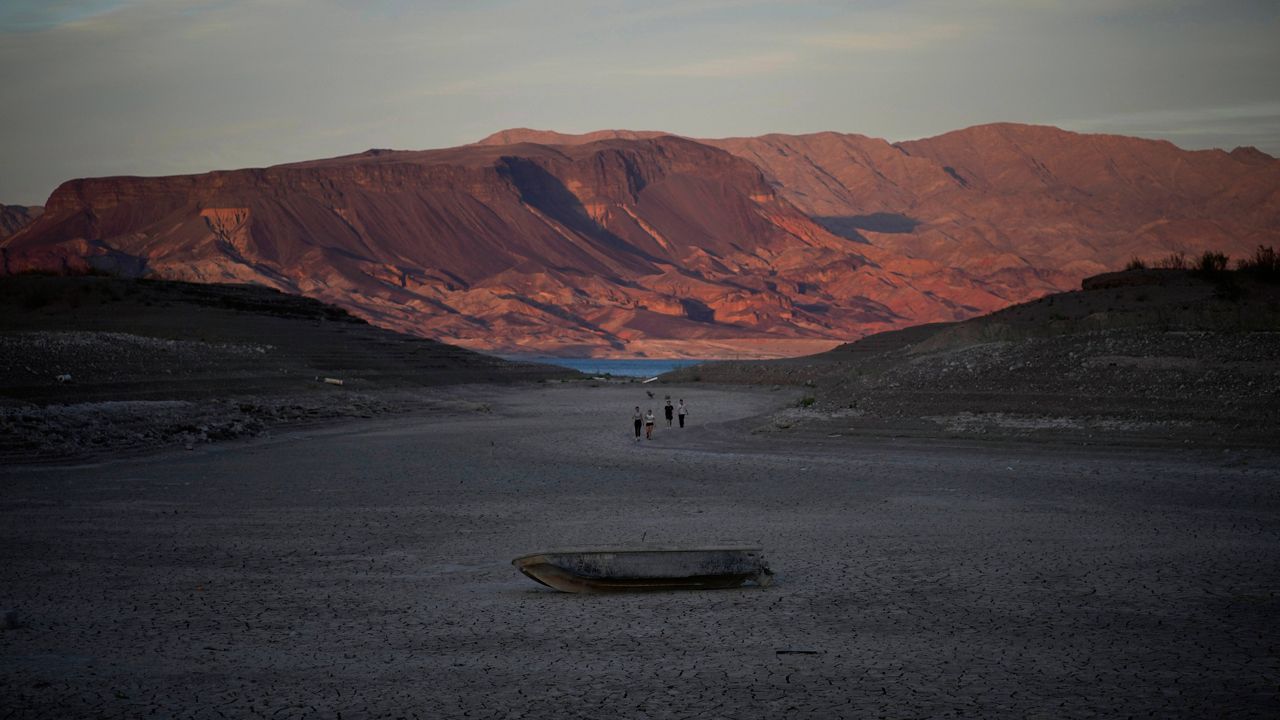 A formerly sunken boat sits on cracked earth Monday hundreds of feet from what is now the shoreline on Lake Mead near Boulder City, Nev. (AP Photo/John Locher)