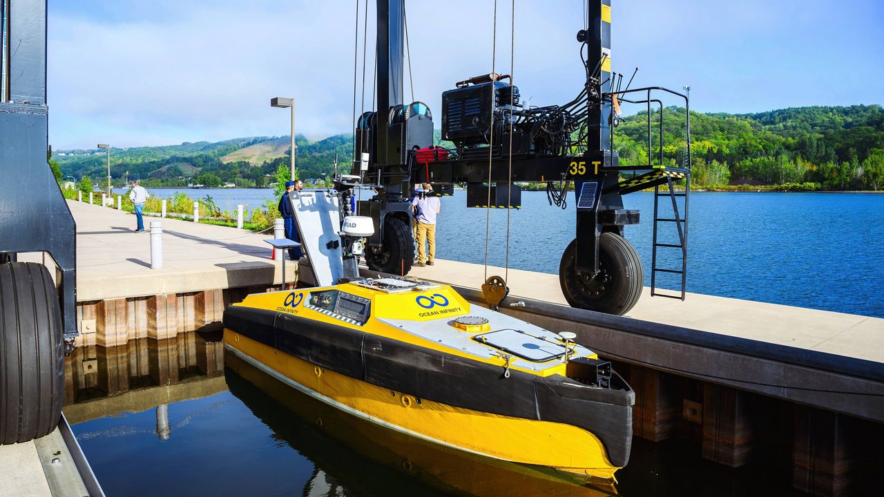 In this photo provided by Michigan Technological University, an autonomous high-tech vessel is lowered in Houghton, Mich., on Monday, Sept. 9. 2024, before being used to search for the wreckage of a plane that crashed in Lake Superior in 1968. 