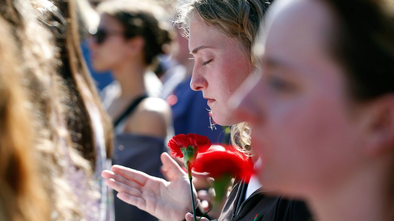 People gather to mourn the loss of Laken Riley during a vigil for the Augusta University College of Nursing student at the Tate Plaza on the University of Georgia campus in Athens, Ga., Monday, Feb. 26, 2024. (Joshua L. Jones/Athens Banner-Herald via AP)