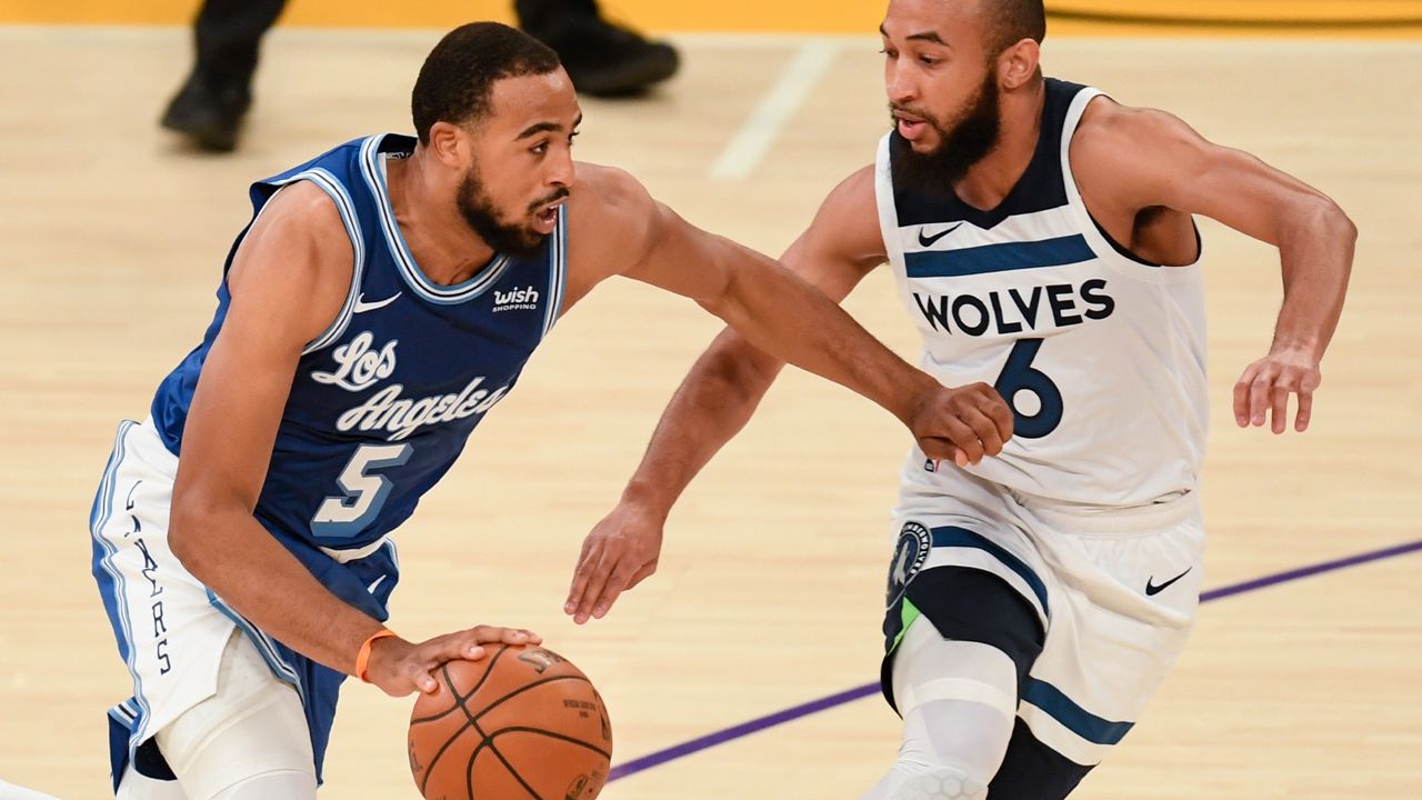 Los Angeles Lakers guard Talen Horton-Tucker, left, drives towards the basket as Minnesota Timberwolves guard Jordan McLaughlin defends during the second half of an NBA basketball game in Los Angeles, Sunday, Dec. 27, 2020. (AP Photo/Kyusung Gong)