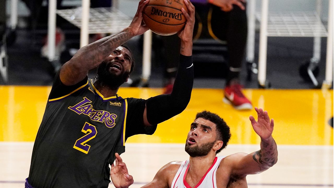 Los Angeles Lakers center Andre Drummond, left, shoots as Houston Rockets forward Anthony Lamb defends during the first half of an NBA basketball game Wednesday, May 12, 2021, in Los Angeles. (AP Photo/Mark J. Terrill)