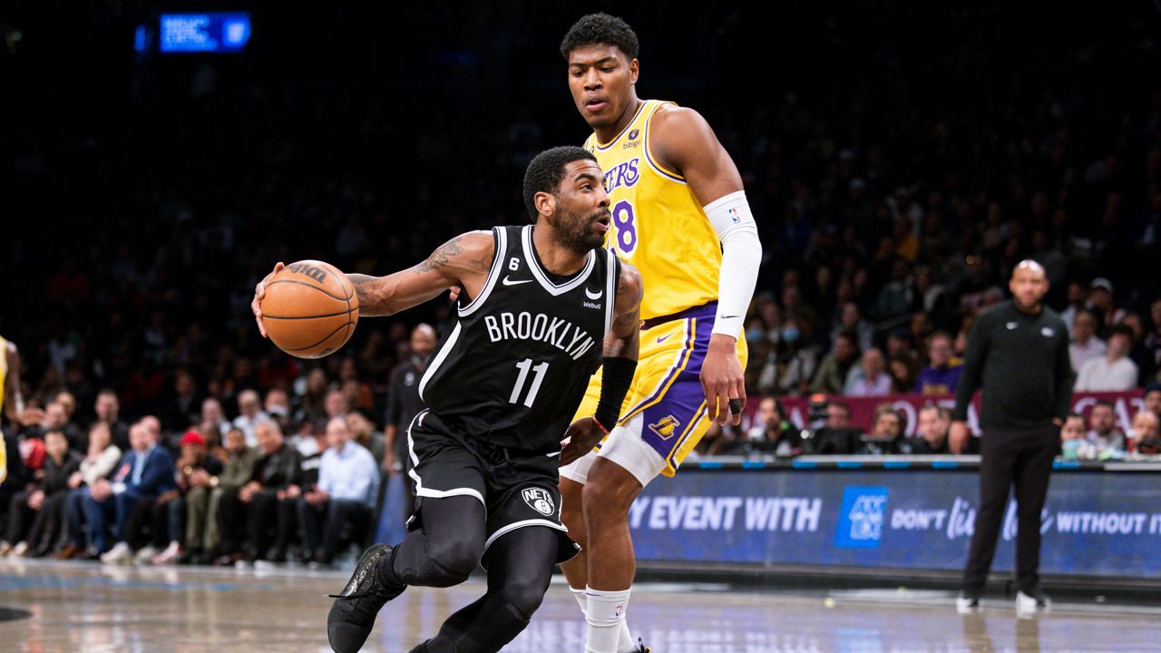 Brooklyn Nets guard Kyrie Irving (11) drives past Los Angeles Lakers forward Rui Hachimura (28) during the first half of an NBA basketball game Monday, Jan. 30, 2023, in New York. (AP Photo/Corey Sipkin)