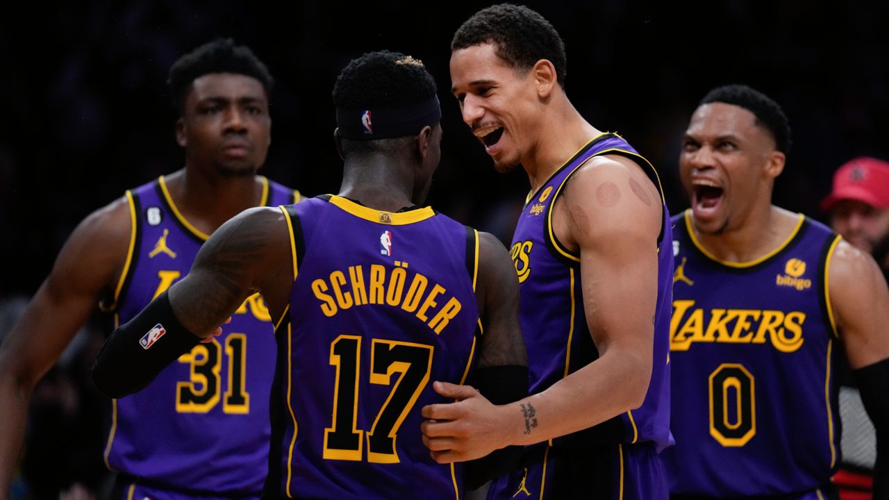 Los Angeles Lakers guard Dennis Schroder (17) celebrates with center Thomas Bryant (31), forward Juan Toscano-Anderson (95) and guard Russell Westbrook (0) after making a shot during the second half of an NBA basketball game against the Memphis Grizzlies in Los Angeles, Friday, Jan. 20, 2023. (AP Photo/Ashley Landis)