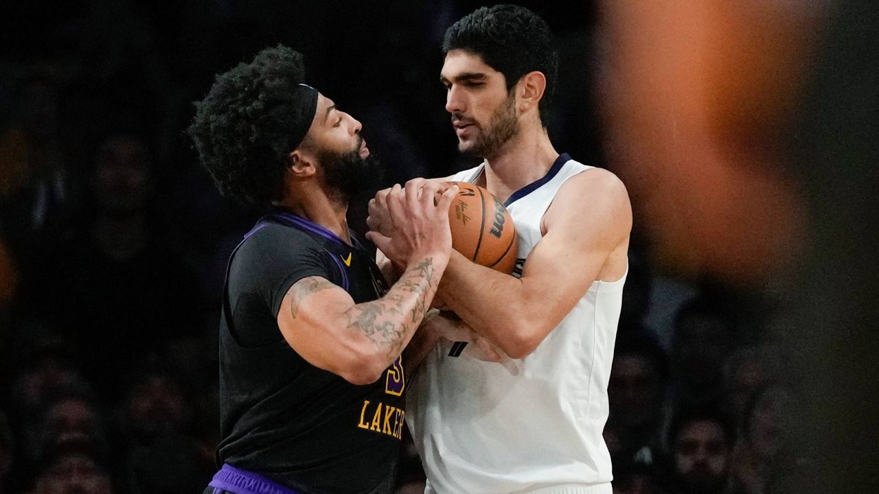 Los Angeles Lakers forward Anthony Davis, left, pushes Memphis Grizzlies forward Santi Aldama after they collided during the first half of an NBA basketball in-season tournament game in LA on Tuesday. (AP Photo/Ashley Landis)