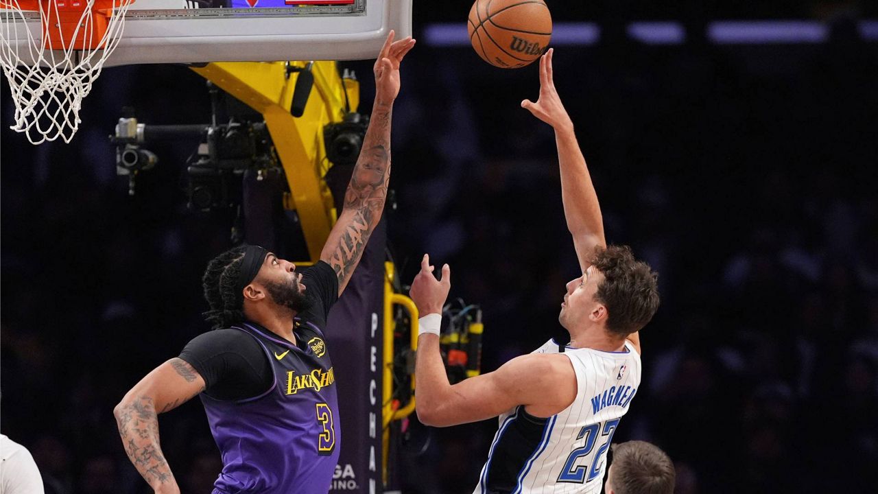 Orlando Magic forward Franz Wagner, right, shoots as Los Angeles Lakers forward Anthony Davis defends during the first half of an NBA basketball game Thursday in LA. (AP Photo/Mark J. Terrill)