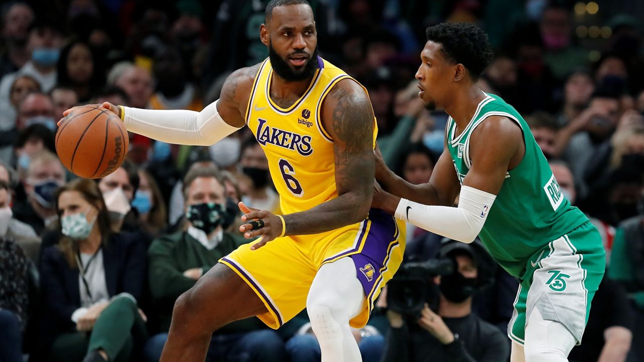 Boston Celtics' Josh Richardson defends against Los Angeles Lakers' LeBron James (6) during the first half of an NBA basketball game, Friday, Nov. 19, 2021, in Boston. (AP Photo/Michael Dwyer)
