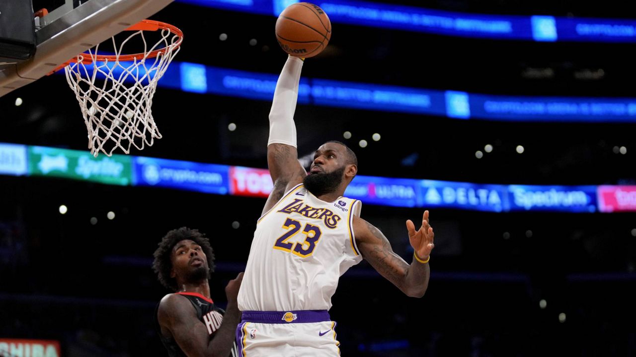 Los Angeles Lakers forward LeBron James (23) dunks over Houston Rockets forward Tari Eason (17) during the second half of an NBA basketball game in LA on Sunday. (AP Photo/Eric Thayer)