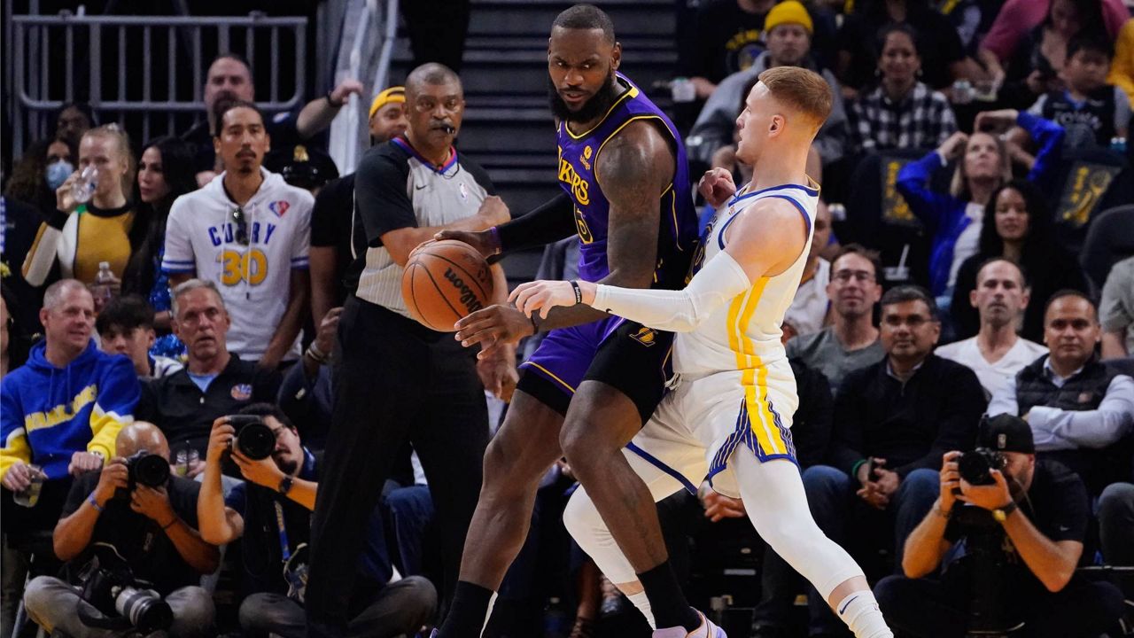 Golden State Warriors guard Donte DiVincenzo, right, defends against Los Angeles Lakers forward LeBron James, left, during the first half of an NBA basketball game in San Francisco on Tuesday. (AP Photo/Godofredo A. Vásquez)