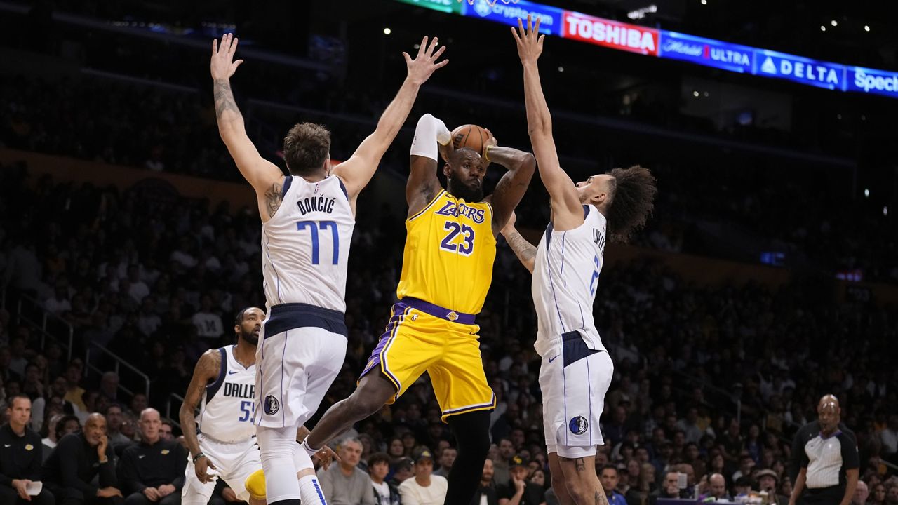 Los Angeles Lakers forward LeBron James, center, reacts after making a 3-point basket during the first half of the team's NBA basketball In-Season Tournament game against the Utah Jazz, Tuesday, Nov. 21, 2023, in Los Angeles. James became the first player in NBA history to surpass 39,000 career points. (AP Photo/Ryan Sun)