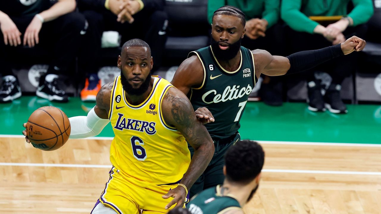 Los Angeles Lakers' LeBron James (6) drives for the basket in front of Boston Celtics' Jaylen Brown (7) during the first half of an NBA basketball game, Saturday, Jan. 28, 2023, in Boston. (AP Photo/Michael Dwyer)