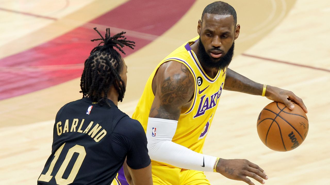 Los Angeles Lakers forward LeBron James is defended by Cleveland Cavaliers guard Darius Garland (10) during the first half of an NBA basketball game Tuesday, Dec. 6, 2022, in Cleveland. (AP Photo/Ron Schwane)