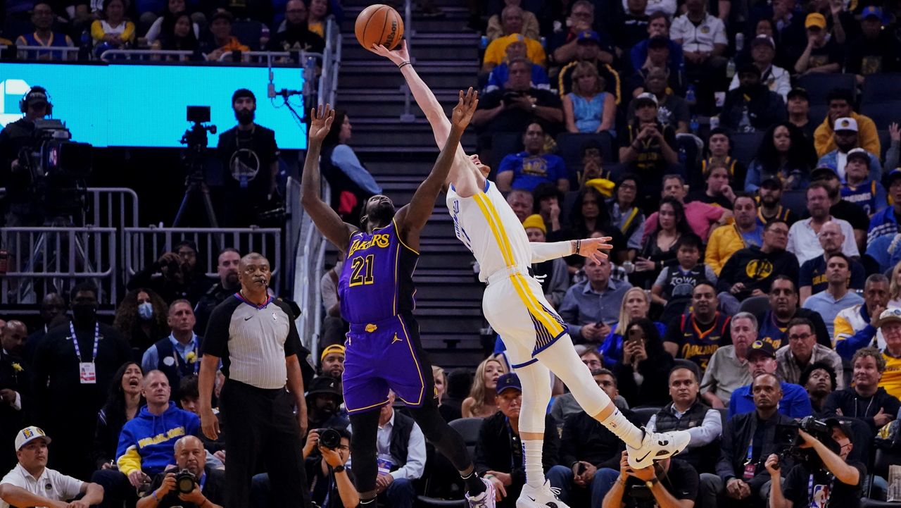 Donte DiVincenzo reaches for a rebound over Patrick Beverley during a game in San Francisco in 2022.