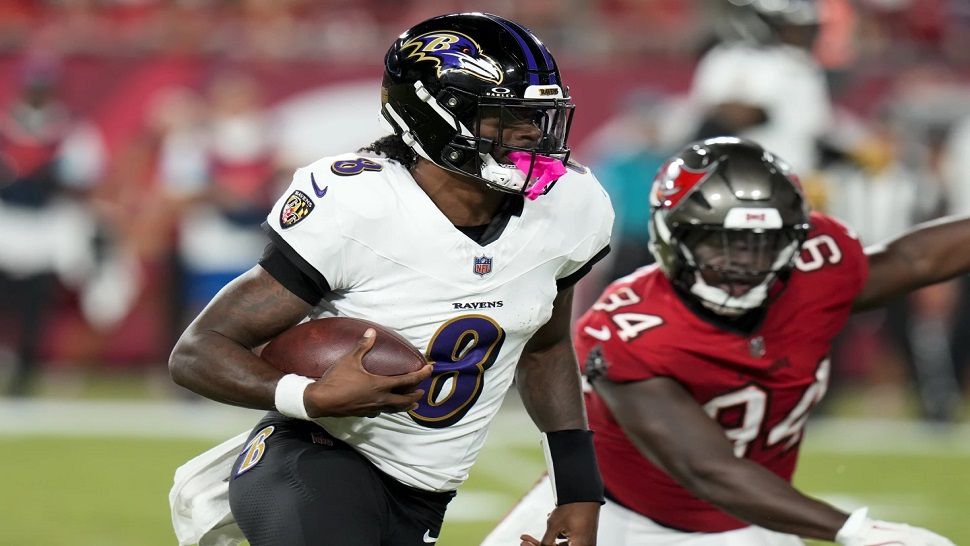 Baltimore Ravens quarterback Lamar Jackson (8) runs past Tampa Bay Buccaneers cornerback Bryce Hall (34) during the first half of an NFL football game, Monday, Oct. 21, 2024, in Tampa, Fla. (AP Photo/Chris O'Meara)