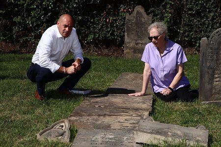 Greg Landsman (R) with his mother, Dr. Lee Hamill, at an ancestor's grave in Chestnut Street Cemetery (Tom Uhlman | Jewish Cemeteries of Greater Cincinnati