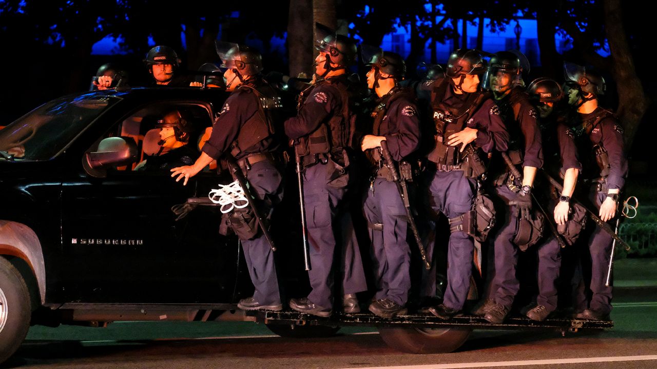 LAPD riot police stand by outside City Hall during a protest of the death of George Floyd, a black man who was in police custody in Minneapolis, in downtown Los Angeles, Wednesday, May 27, 2020. (AP Photo/Ringo H.W. Chiu)