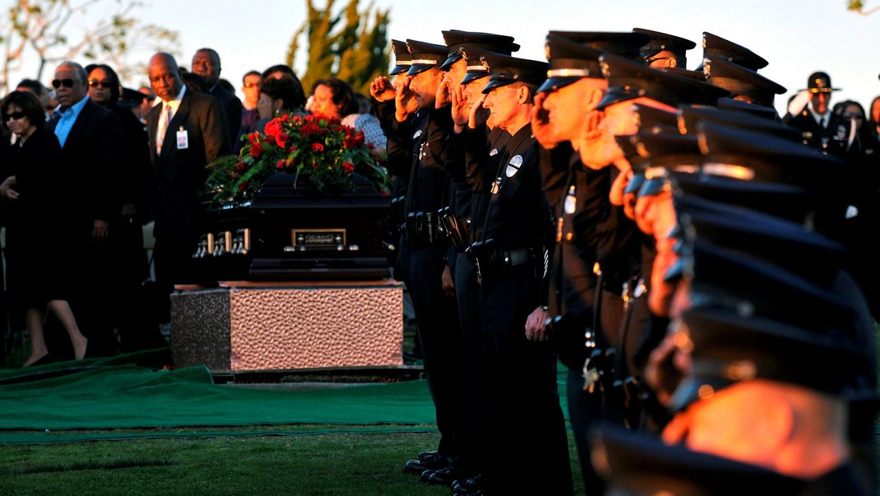 Los Angeles Police Department officers attend a graveside service for Los Angeles Police Officer Randal Simmons at Holly Cross Cemetery in Culver City, Calif. Friday, Feb. 15, 2008. (AP Photo/John McCoy, Pool )