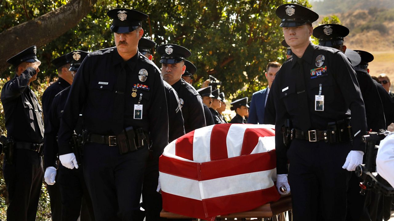 Los Angeles Police Department officers carry the casket of LAPD Officer Houston R. Tipping at the beginning of his memorial service on Wednesday, June 22, 2022, at Forest Lawn Hollywood Hills in Los Angeles. (Carolyn Cole/Los Angeles Times via AP, Pool)