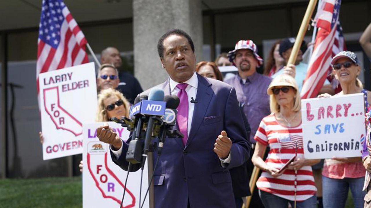 In this July 13, 2021 file photo radio talk show host Larry Elder speaks to supporters during a campaign stop in Norwalk, Calif. Elder has announced his candidacy for governor in the Sept. 14 recall election but the California Secretary of State's office has rejected his candidacy saying Elder, a Republican, filed incomplete tax returns that are required to run. Elder is challenging the decision. (AP Photo/Marcio Jose Sanchez, File)