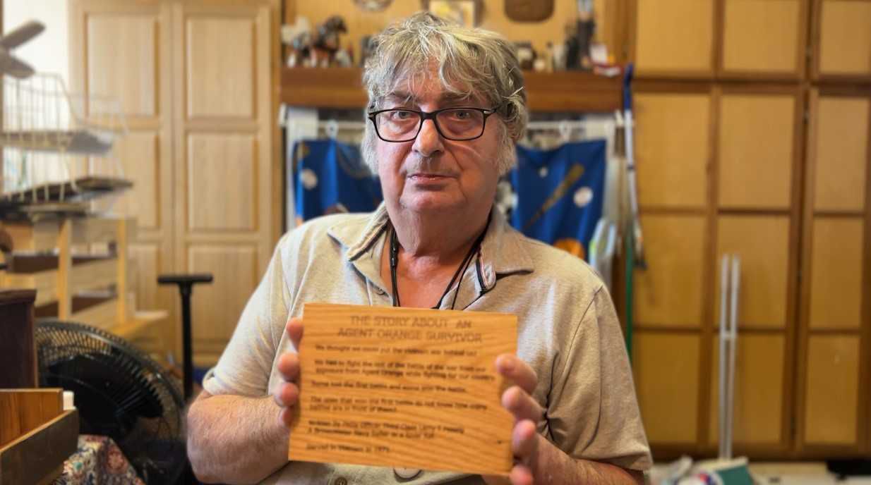 Larry Peissig holds the poem he wrote, about his battle with cancer from Agent Orange exposure.