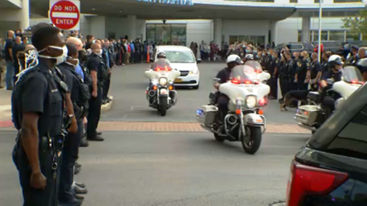 The procession of officers and supporters outside Upstate Medical Hospital