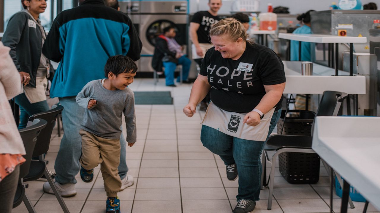 The Laundry Projects brings in volunteers who take over the laundromat, greeting and helping everyone who comes in the doors. (Photo courtesy of The Laundry Project)