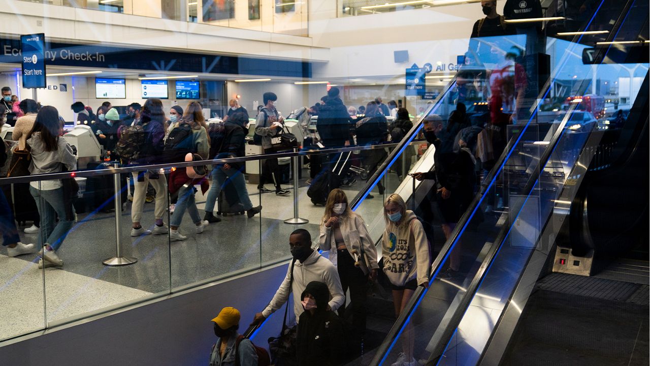 Travelers crowd the United Airlines check-in area at the Los Angeles International Airport in Los Angeles, Wednesday, Nov. 24, 2021. (AP Photo/Jae C. Hong)