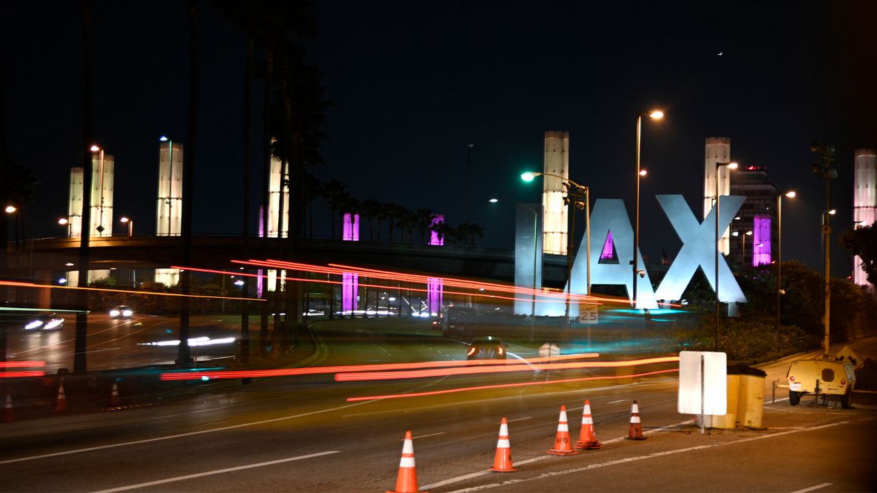 Lights of purple and gold illuminate the pylons outside of LAX in remembrance of former NBA basketball player Kobe Bryant in Los Angeles, Sunday, Jan. 26, 2020. (AP Photo/Kelvin Kuo)