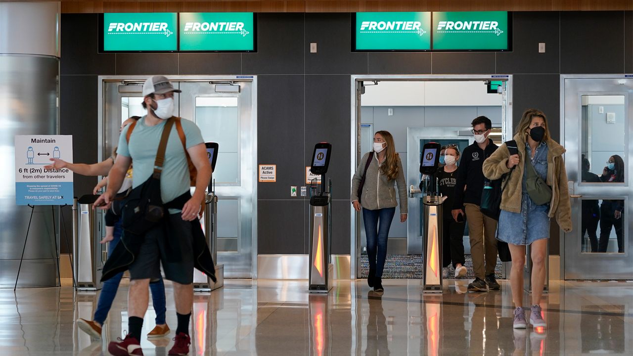 In this May 24, 2021, file photo, passengers arrive at the new West Gates at Tom Bradley International Terminal at Los Angeles International Airport in Los Angeles. (AP Photo/Ashley Landis, File)