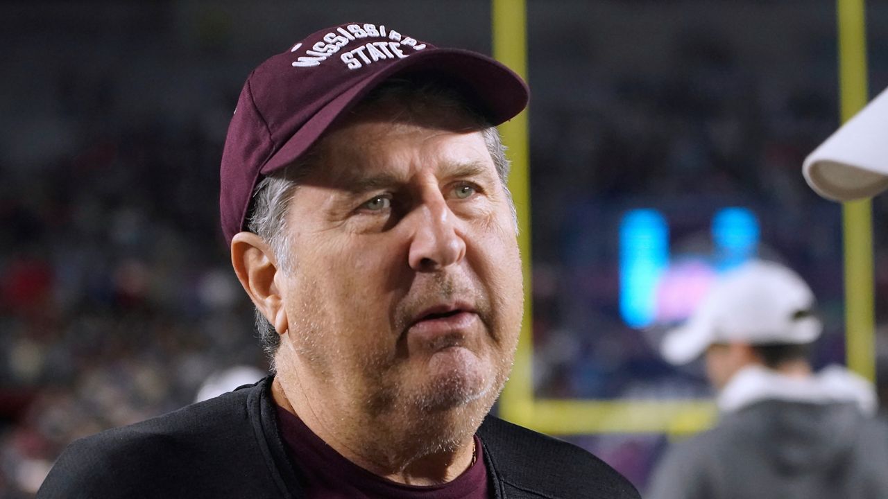 Mississippi State coach Mike Leach talks with Mississippi coach Lane Kiffin before an NCAA college football game in Oxford, Miss., Thursday, Nov. 24, 2022. (AP Photo/Rogelio V. Solis)