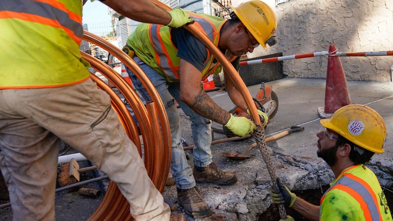 Workers repairing water pipes