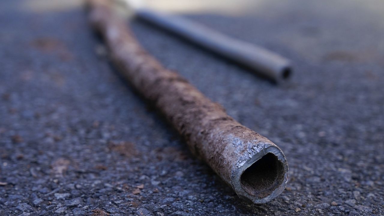 Lead water pipes pulled from underneath the street are seen in Newark, N.J., Oct. 21, 2021. (AP Photo/Seth Wenig, File)