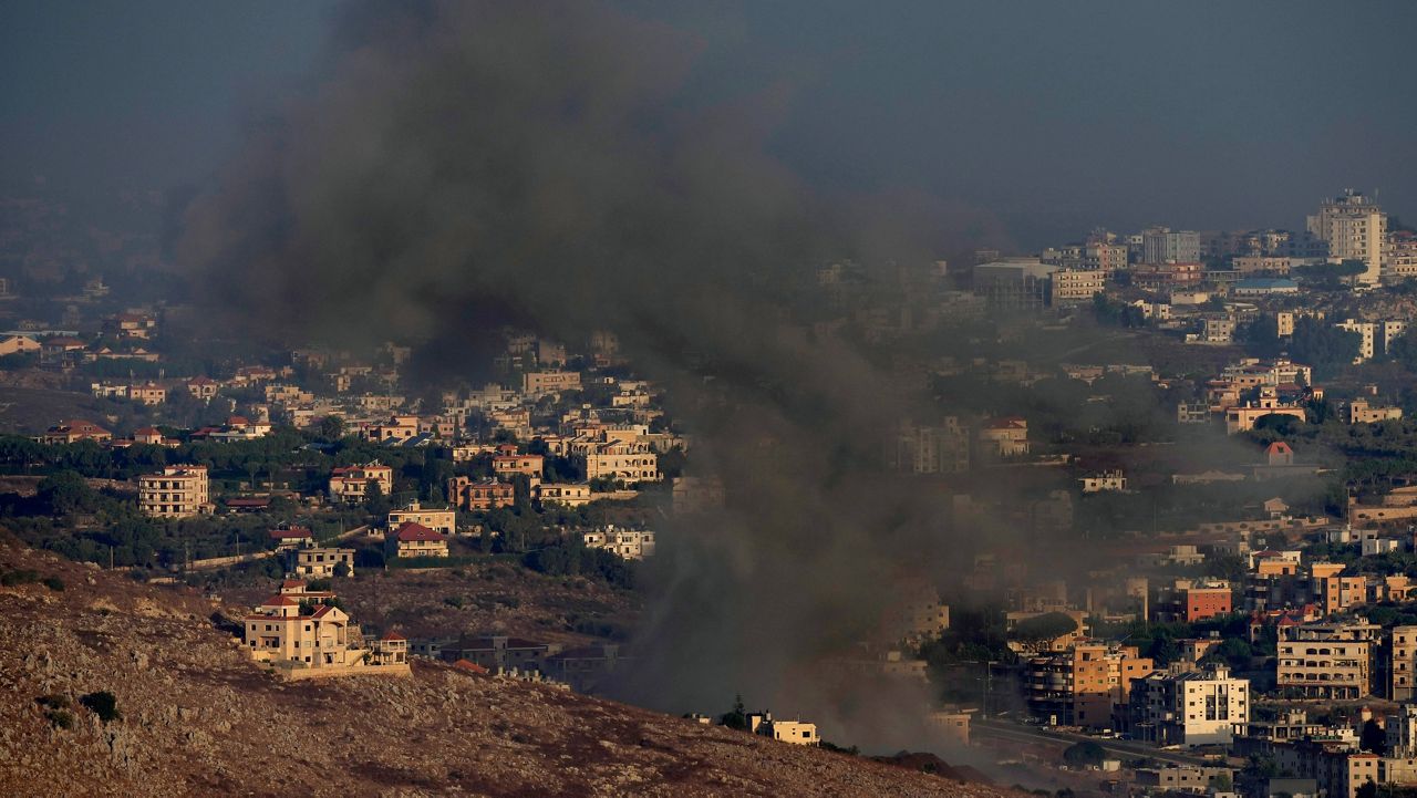 Smoke rises from an Israeli airstrike on Kfar Rouman village, as seen from Marjayoun town, south Lebanon, Monday, Sept. 23, 2024. (AP Photo/Hussein Malla)