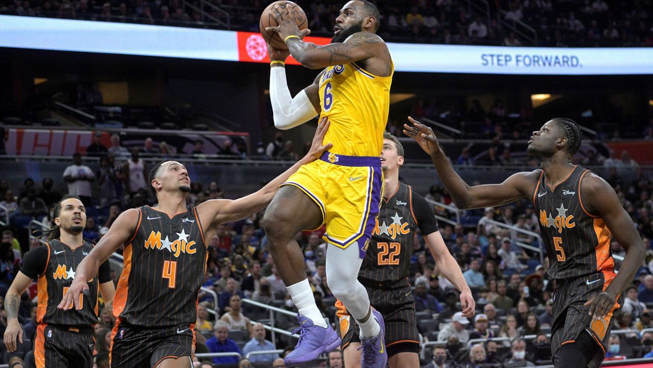 Los Angeles Lakers forward LeBron James (6) goes up to shoot between Orlando Magic guard Cole Anthony, left, guard Jalen Suggs (4), forward Franz Wagner (22) and center Mo Bamba (5) during the first half of an NBA basketball game, Friday, Jan. 21, 2022, in Orlando, Fla. (AP Photo/Phelan M. Ebenhack)