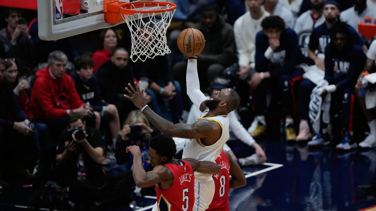 Los Angeles Lakers forward LeBron James (6)goes to the basket against New Orleans Pelicans forward Herbert Jones (5) and forward Naji Marshall (8) in the first half of an NBA basketball game in New Orleans on Saturday. (AP Photo/Gerald Herbert)