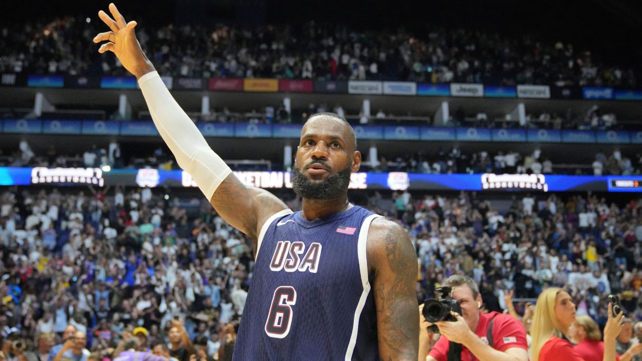 United States' forward LeBron James waves to the crowd after the end of an exhibition basketball game between the United States and South Sudan, at the o2 Arena in London on Saturday. (AP Photo/Kin Cheung)