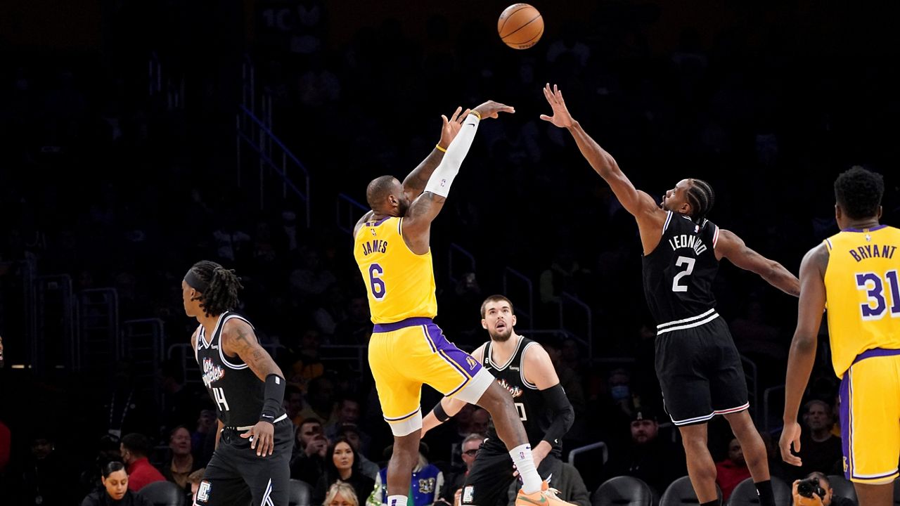 Los Angeles Lakers forward LeBron James (6) shoots as Los Angeles Clippers forward Kawhi Leonard (2) defends and guard Terance Mann (14), center Ivica Zubac (40) and center Thomas Bryant watch during the first half of an NBA basketball game Tuesday, Jan. 24, 2023, in Los Angeles. (AP Photo/Mark J. Terrill)