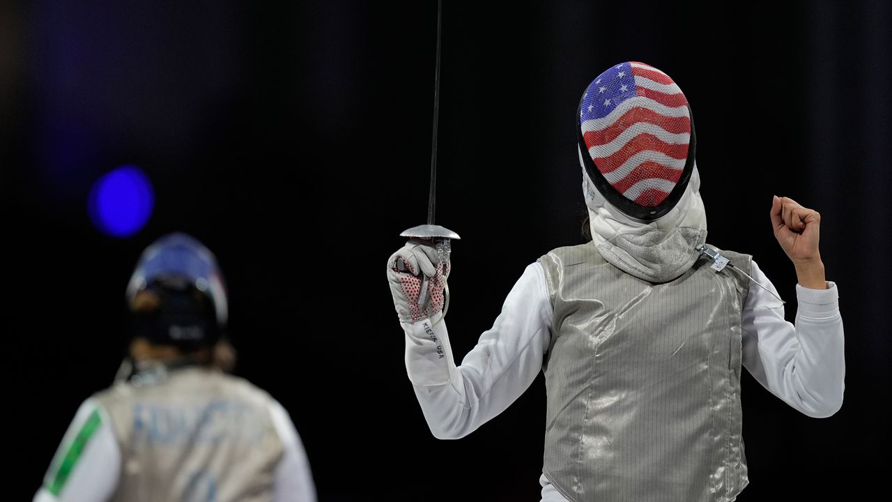 United States' Lee Kiefer, right, reacts as she competes with Italy's Martina Favaretto in the women's team foil final match during the 2024 Summer Olympics at the Grand Palais, Thursday, Aug. 1, 2024, in Paris, France. (AP Photo/Rebecca Blackwell)