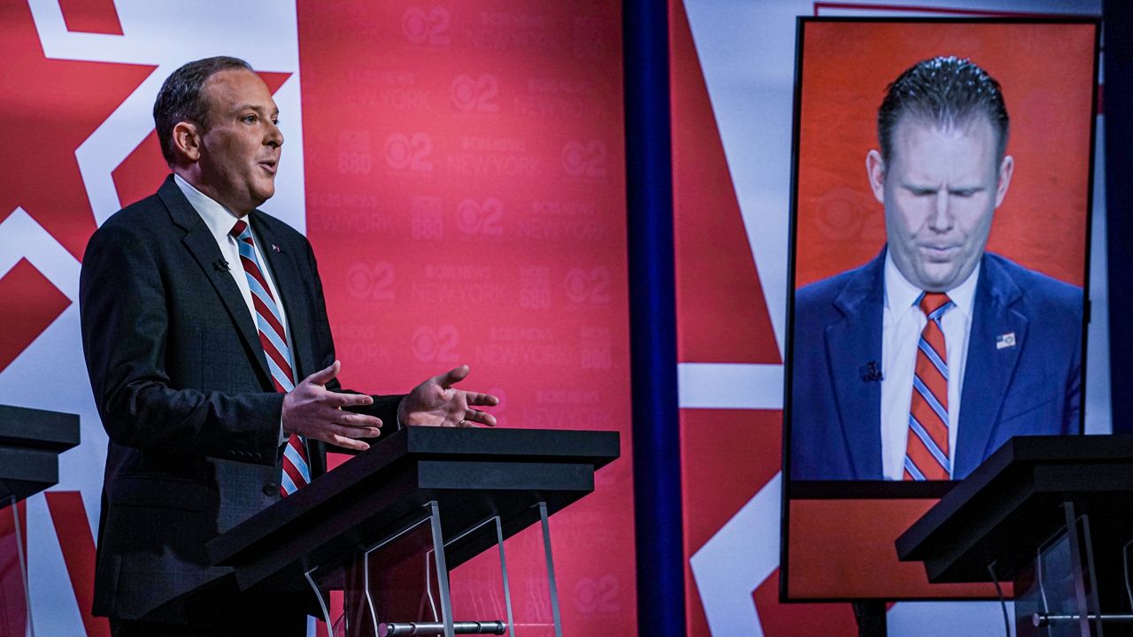 Suffolk County Congressman Lee Zeldin, left, listens as Andrew Giuliani, right, son of former New York City Mayor Rudy Giuliani, speaks during New York's Republican gubernatorial debate at the studios of CBS2 TV, Monday June 13, 2022, in New York. Giuliani participated via virtual broadcast after he was blocked from the studios for not meeting vaccine requirements. (AP Photo/Bebeto Matthews)