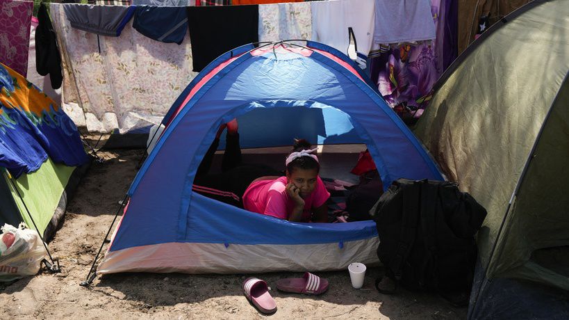 A Venezuelan migrant rests inside her tent on the bank of the Rio Grande in Matamoros, Mexico, Sunday, May 14, 2023. As the U.S. ended its pandemic-era immigration restrictions, migrants are adapting to new asylum rules and legal pathways meant to discourage illegal crossings. (AP Photo/Fernando Llano)