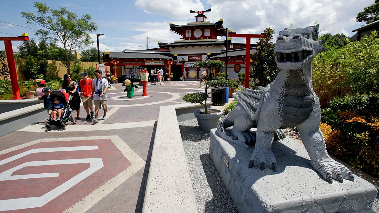 A Lego dragon greets park guests as they enter Ninjago World at Legoland Florida in Winter Haven, Fla. (AP Photo/John Raoux)