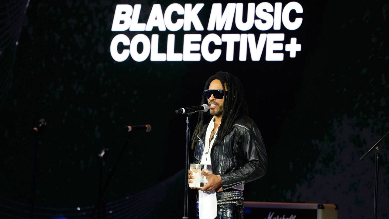 Four-time Grammy-winning artist Lenny Kravitz receives the Recording Academy Global Impact Award at the third annual Recording Academy Honors Presented by The Black Music Collective in Los Angeles on Thursday. (AP Photo/Damian Dovarganes)