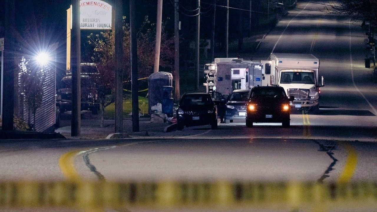 Police tape cordons off the road to Schemengees Bar and Grille as law enforcement officers maintain their presence in the aftermath of a mass shooting by Army reservist Robert Card in Lewiston, Maine, Oct. 27, 2023. Sean Hodgson, a fellow U.S. Army reservist who sounded the clearest warning ahead of Maine’s deadliest mass shooting, is expected to answer questions Thursday, April 25, 2024, from the commission investigating the tragedy. (AP Photo/Matt Rourke, File)