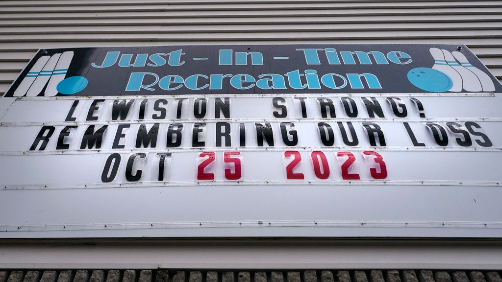 A sign stating "Lewiston Strong!" is displayed outside the Just-In-Time bowling alley, one of the sites of the Lewiston shootings, Wednesday, Dec. 27, 2023, in Lewiston, Maine. Immediately after Maine's deadliest mass shooting, the owners of the bowling alley and the bar in Lewiston where the gunman killed a total of 18 people were certain their doors were closed for good. But as time passed following the Oct. 25 shooting, they came to the same conclusion: They had to reopen. (AP Photo/Charles Krupa)