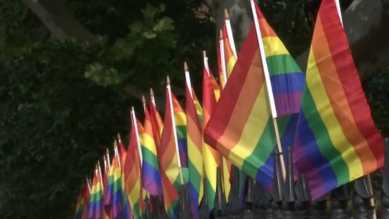 FILE - LGBTQ flags.