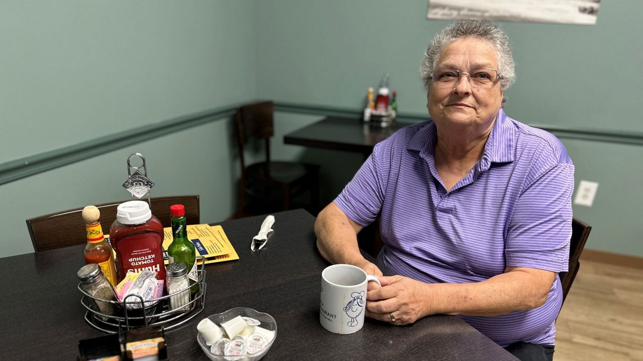 Chris Mathews, sitting at Eve’s Family Restaurant in Oldsmar. She frequented it often with her wife, before she passed away from Alzheimer’s complications. (Spectrum News)