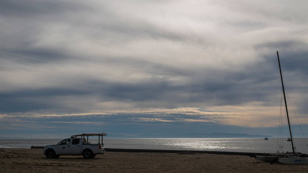 A California State Parks lifeguard patrols Twin Lakes State Beach in Santa Cruz, Calif., Jan. 15, 2022.(AP Photo/Nic Coury)