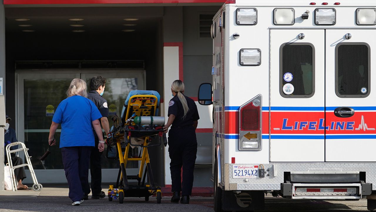 In this Jan. 5, 2021 file photo a LifeLine Ambulance arrives at the CHA Hollywood Presbyterian Medical Center (CHA HPMC) in Los Angeles. (AP Photo/Damian Dovarganes, File)