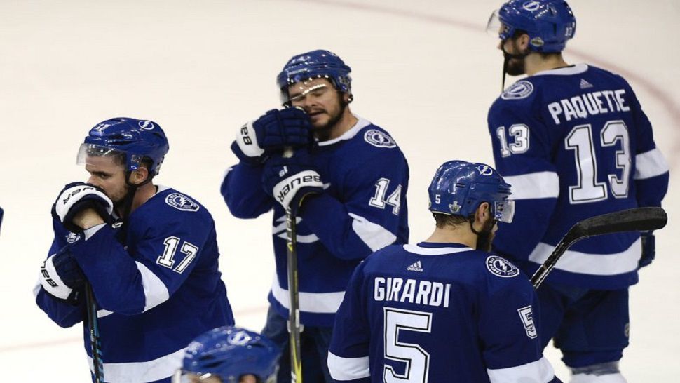Tampa Bay Lightning’s Alex Killorn (17), Chris Kunitz (14), Dan Girardi (5) and Cedric Paquette (13) watch the Washington Capitals celebrate a 4-0 win in Game 7 of the NHL Eastern Conference finals hockey playoff series Wednesday, May 23, 2018, in Tampa, Fla. (AP Photo/Jason Behnken)